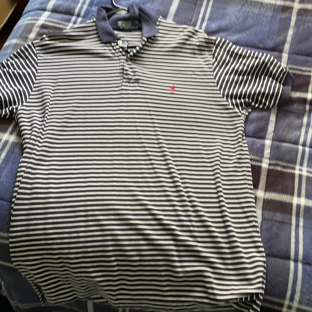 Navy blue and white stripes men’s polo with red logo. Barely used.